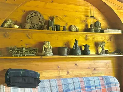 a wooden shelf with various items on it at Artistic Garden House in Cetinje