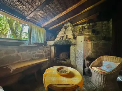 a room with a table and a stone oven at Artistic Garden House in Cetinje
