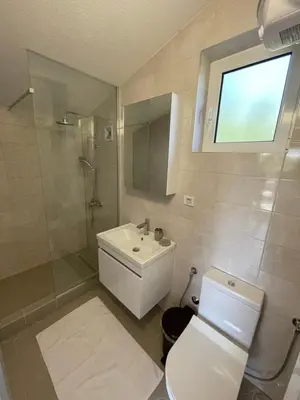 a bathroom with a white toilet and a sink at Grapefruit Haus in Donji Štoj