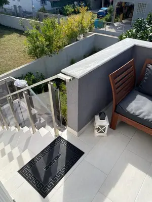 a patio with a bench and a table on a balcony at Grapefruit Haus in Donji Štoj