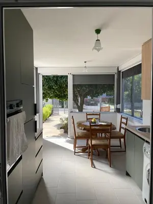 a kitchen and dining room with a table and chairs at Grapefruit Haus in Donji Štoj
