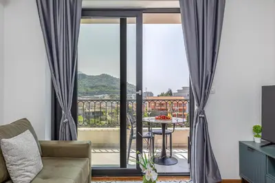 a living room with a view of a balcony at Adriatic Residence in Budva