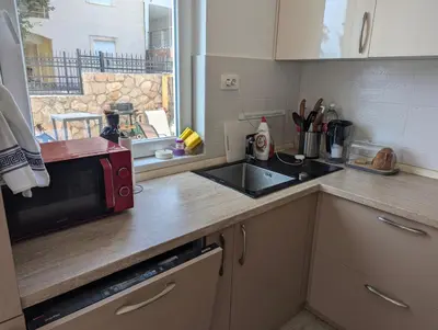 a kitchen with a sink and a microwave at Villa Seventh Heaven in Sutomore