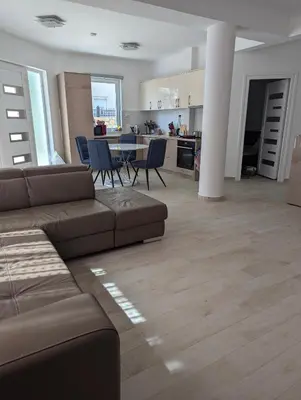 a living room with a couch and a table with chairs at Villa Seventh Heaven in Sutomore