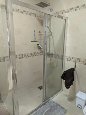 a shower with a glass door in a bathroom at Villa Seventh Heaven in Sutomore