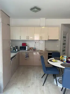 a small kitchen with a table and chairs and a table and a tablektop at Villa Seventh Heaven in Sutomore