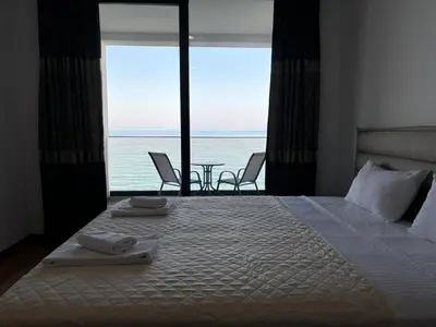 a bedroom with a bed and a view of the ocean at Hotel Sutomore in Sutomore