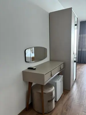 a dressing table with a mirror in a room at Hotel Sutomore in Sutomore