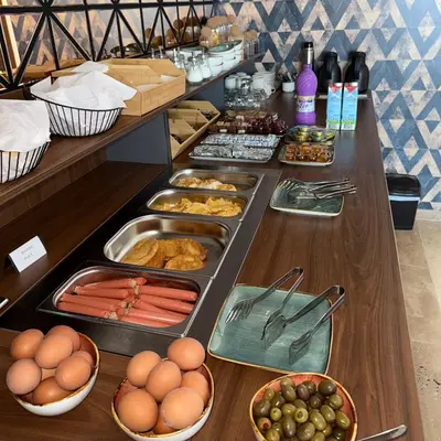 a buffet with eggs and food on a table at Hotel Sutomore in Sutomore