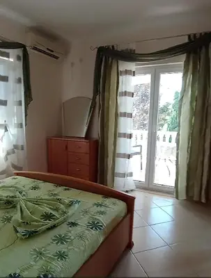 a bedroom with a bed and a large window at Villa Delfin 1-2-3-4 in Bar