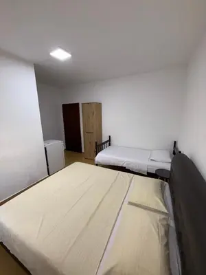 a room with two beds and a door in it at Apartments Lazo in Ulcinj