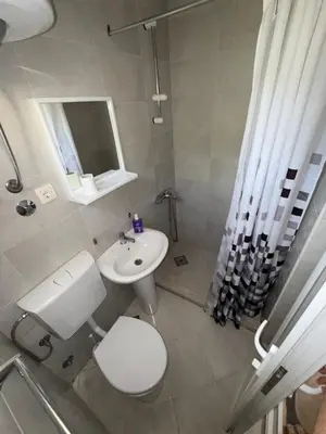 a bathroom with a white toilet and a sink at Apartments Lazo in Ulcinj