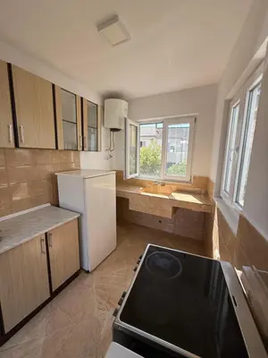 a kitchen with a white refrigerator and a stove at Apartments Lazo in Ulcinj