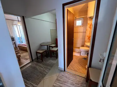 a small bathroom with a toilet and a table at Guest House Plima 2 in Budva