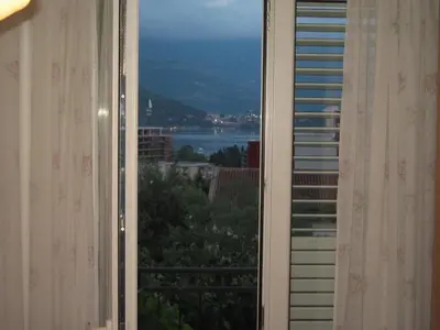 an open window with a view of the water at Guest House Plima 2 in Budva