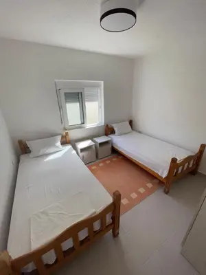 a room with two beds and a window at Grapefruit Home Apartment Ulcinj Montenegro in Donji Štoj