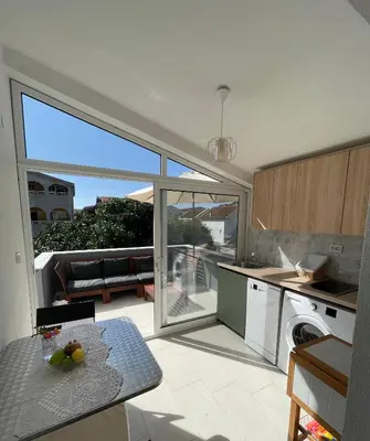 a kitchen with a large sliding glass door to a patio at Grapefruit Home Apartment Ulcinj Montenegro in Donji Štoj