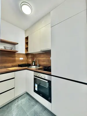a kitchen with white cabinets and a black oven at One bedroom Apartment 777 in Budva