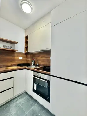 a kitchen with white cabinets and a black oven at One bedroom Apartment 777 in Budva