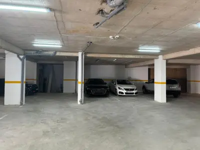 a parking garage with three cars parked in it at One bedroom Apartment 777 in Budva