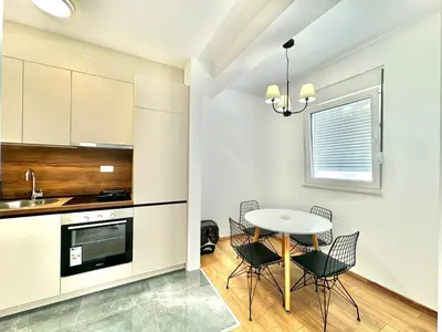 a kitchen and dining room with a table and chairs at One bedroom Apartment 777 in Budva