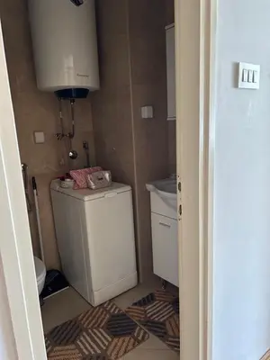 a small bathroom with a toilet and a sink at Apartman Bešović Cetinje in Cetinje