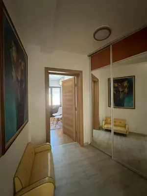 a living room with a couch and a mirror at Apartments Martinovic Toplis in Budva