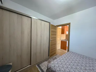 a bedroom with a bed and wooden cabinets at Apartments Martinovic Toplis in Budva