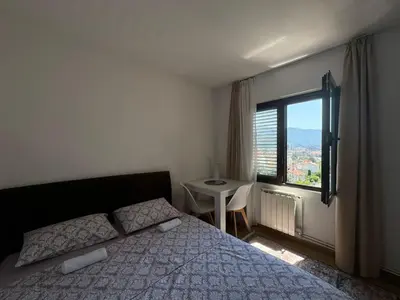 a bedroom with a bed and a large window at Apartments Martinovic Toplis in Budva