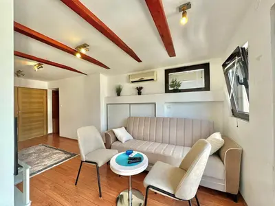 a living room with a couch and chairs and a table at Apartments Martinovic Toplis in Budva
