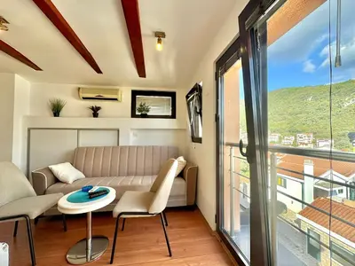 a living room with a couch and a table at Apartments Martinovic Toplis in Budva