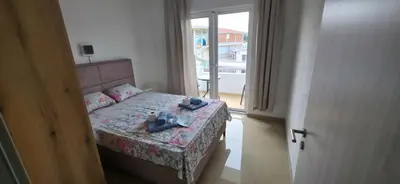 a small bedroom with a bed and a window at Villa Grafenberg Ulcinj in Ulcinj
