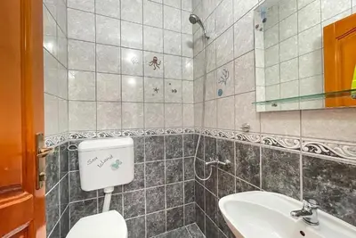 a bathroom with a toilet and a sink at Villa Grafenberg Ulcinj in Ulcinj