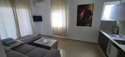 a small living room with a couch and a kitchen at Villa Grafenberg Ulcinj in Ulcinj