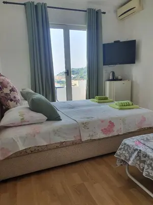 a bedroom with a large bed and a window at Villa Grafenberg Ulcinj in Ulcinj