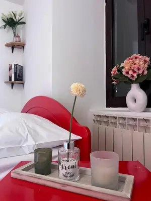 a tray with a candle and a flower on a table at Apartment Sofija in Kotor