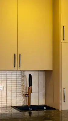 a kitchen with yellow cabinets and a sink at Sveti Luka private beach in Dobra Voda