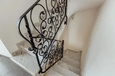 a stairway with a wrought iron railing at Villa Sveti Stefan in Budva