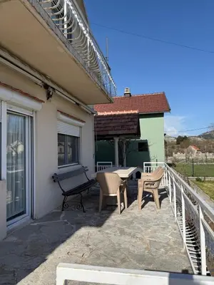a patio with a bench and a table and chairs at Family house on the mountain - Krstac, Njegusi in Njeguši