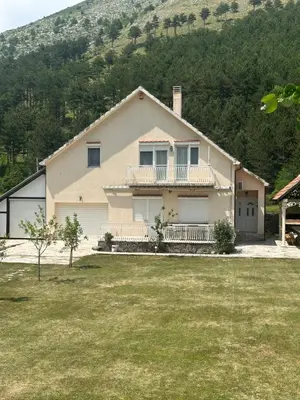 a house with a large yard in front of a mountain at Family house on the mountain - Krstac, Njegusi in Njeguši