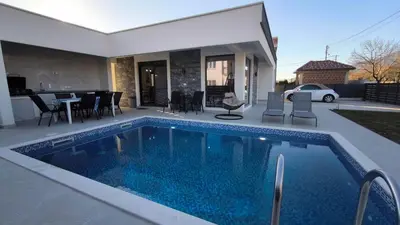 a swimming pool in the backyard of a house at Poolside Idyll in Bar