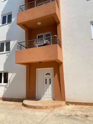 a dog sitting on the balcony of a building at Nike's Apartment in Dobra Voda