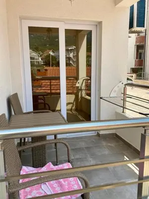 a balcony with a table and chairs on a patio at Nike's Apartment in Dobra Voda
