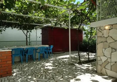 a table and chairs sitting under a canopy at Iva Guest House in Sutomore