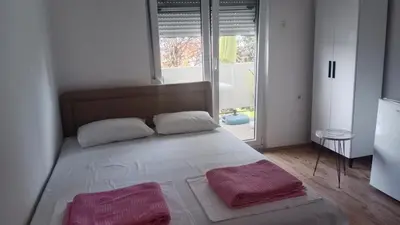 a bedroom with a bed with two pink towels on it at Studio Dream I I in Bar, Susanj