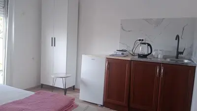 a kitchen with a sink and a white refrigerator at Studio Dream I I in Bar, Susanj