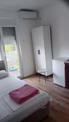 a bedroom with a bed and a cabinet and a window at Studio Dream I I in Bar, Susanj