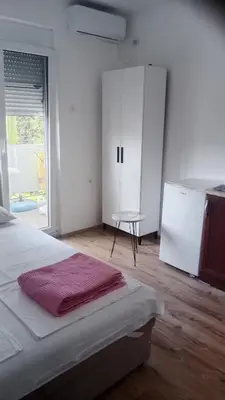 a bedroom with a bed and a white cabinet at Studio Dream I I in Bar, Susanj