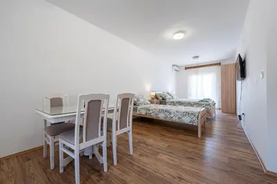 a living room with a table and chairs and a couch at Four Seasons Villa Valentina in Kotor