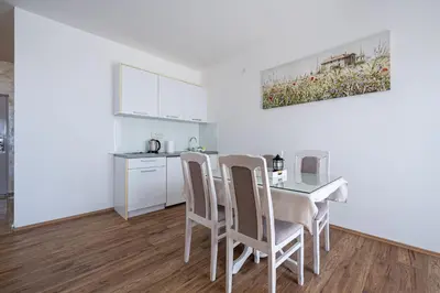 a kitchen and dining room with a table and chairs at Four Seasons Villa Valentina in Kotor